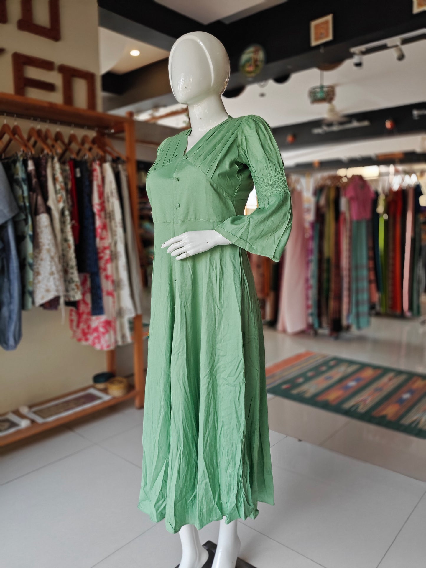 Sea green rayon pleated yoke dress with buttons detailing