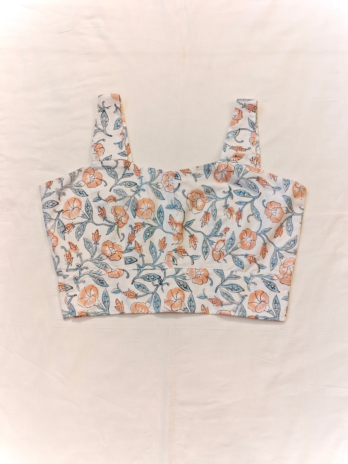Orange floral prints on white base sleeveless blouse / crop top