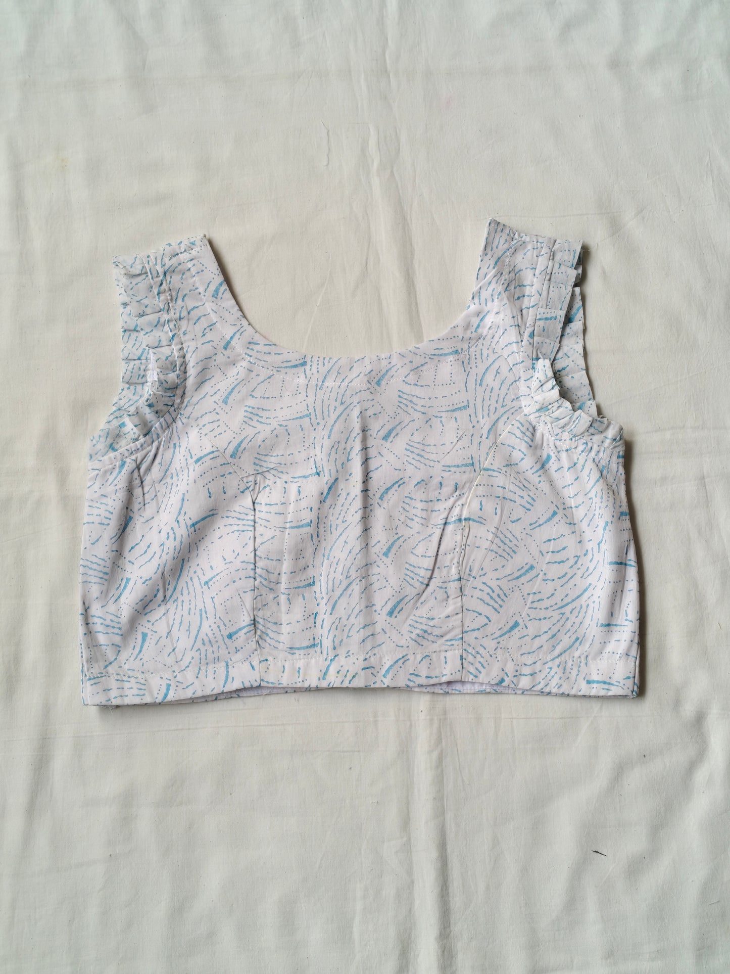 Blue hand block printed design on white cotton sleeveless blouse