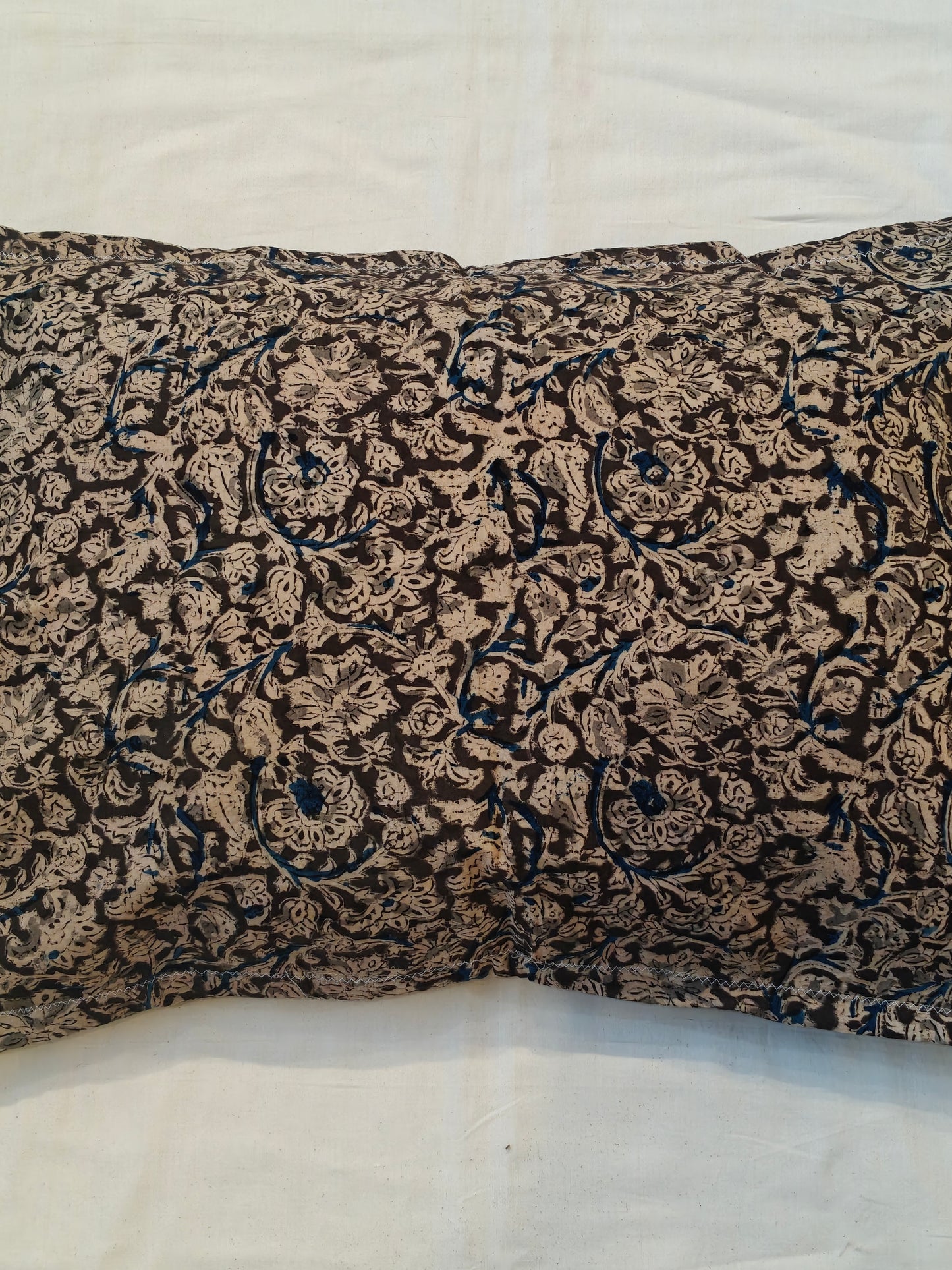 Handcrafted pillow cover featuring floral Kalamkari patterns