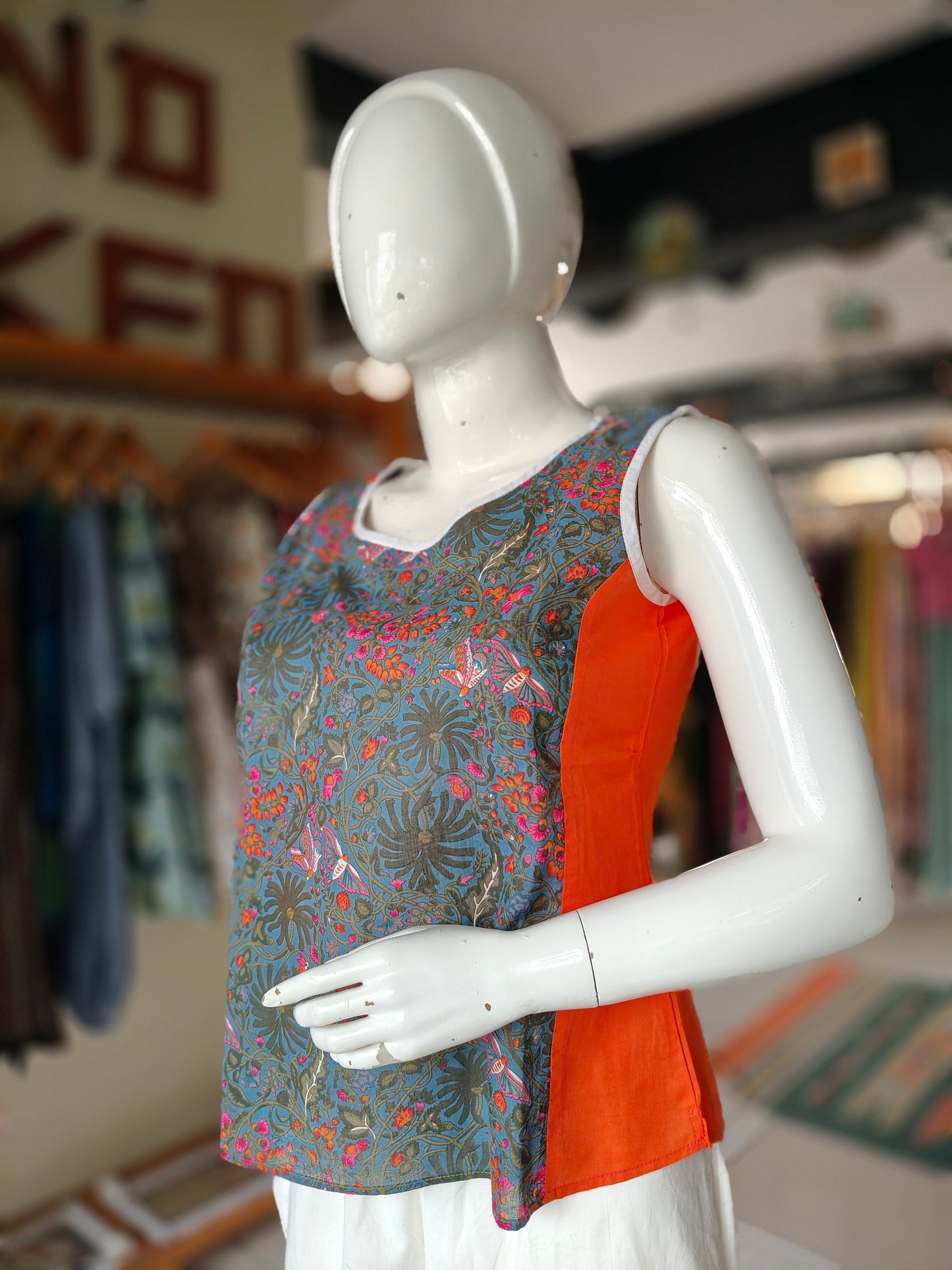 Green and orange flies and floral printed sleeveless top