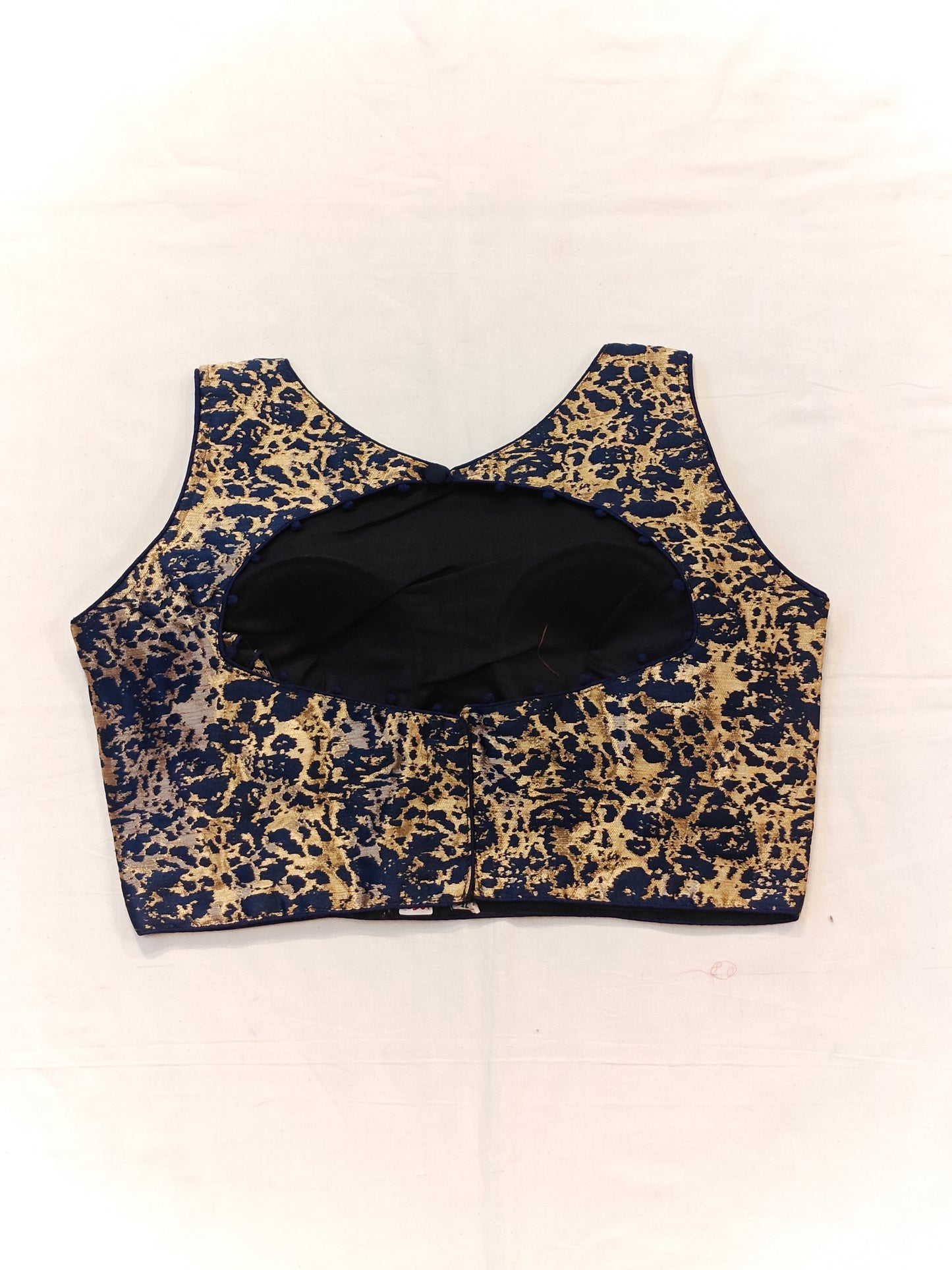 Blue and golden sleeveless blouse