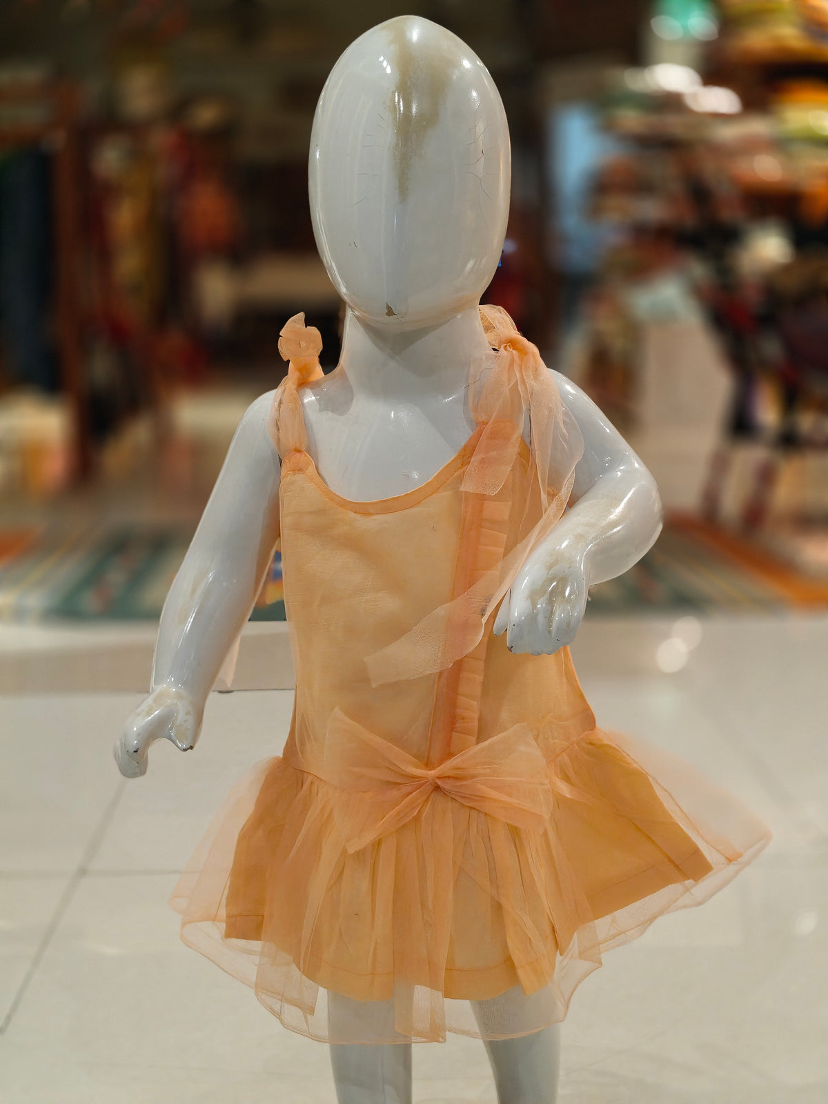 Peach sleeveless net frock for girls with shoulder ties and lining