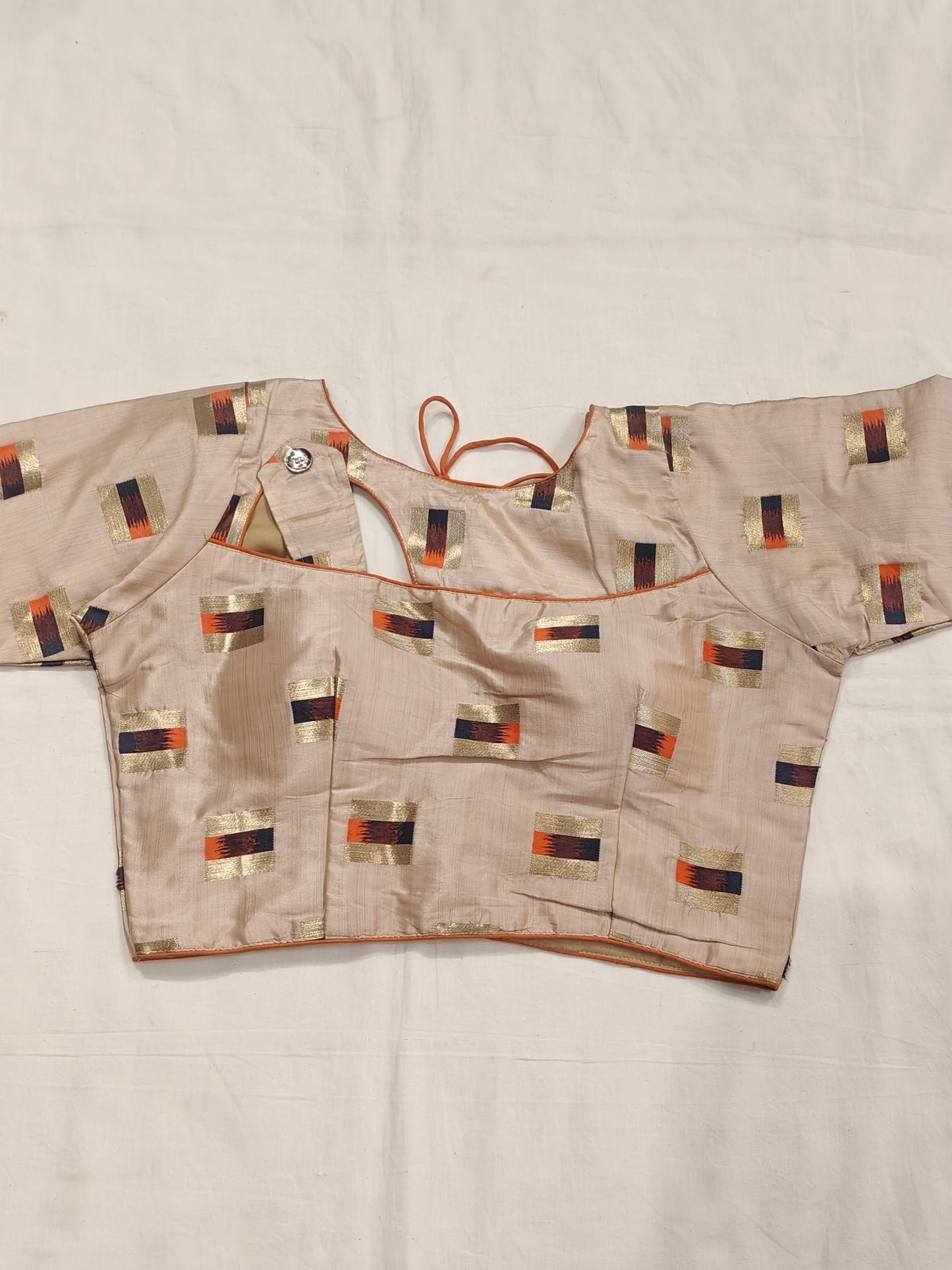Gold orange design on cream base blouse with fancy neck cut