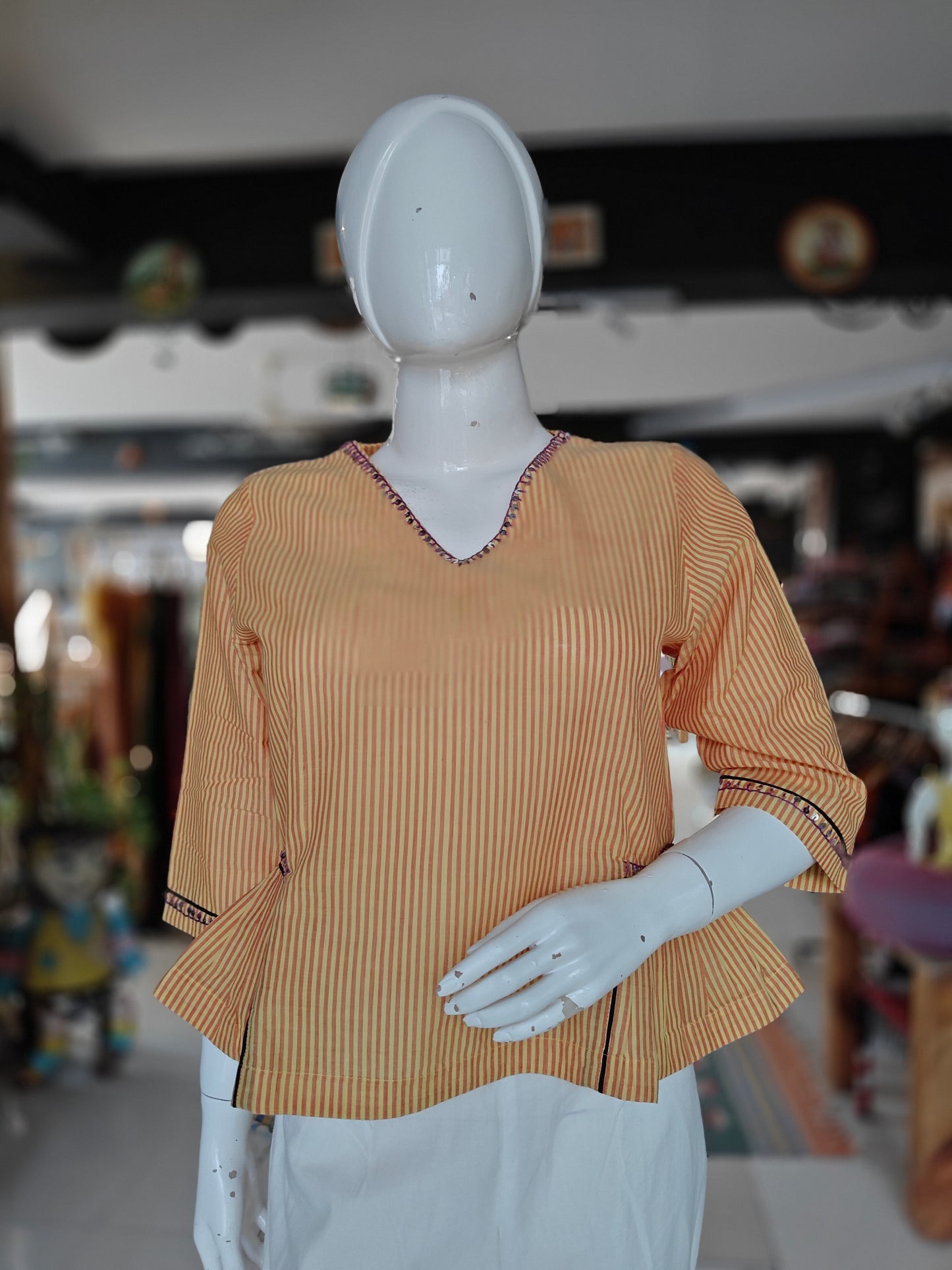 Orange and white striped cotton peplum top with embroidered V neck and sleeves