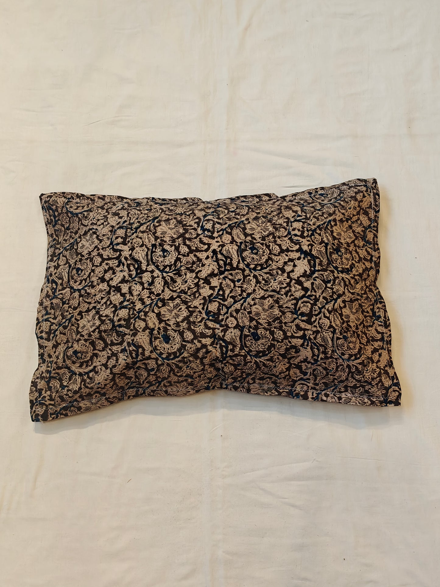 Handcrafted pillow cover featuring floral Kalamkari patterns