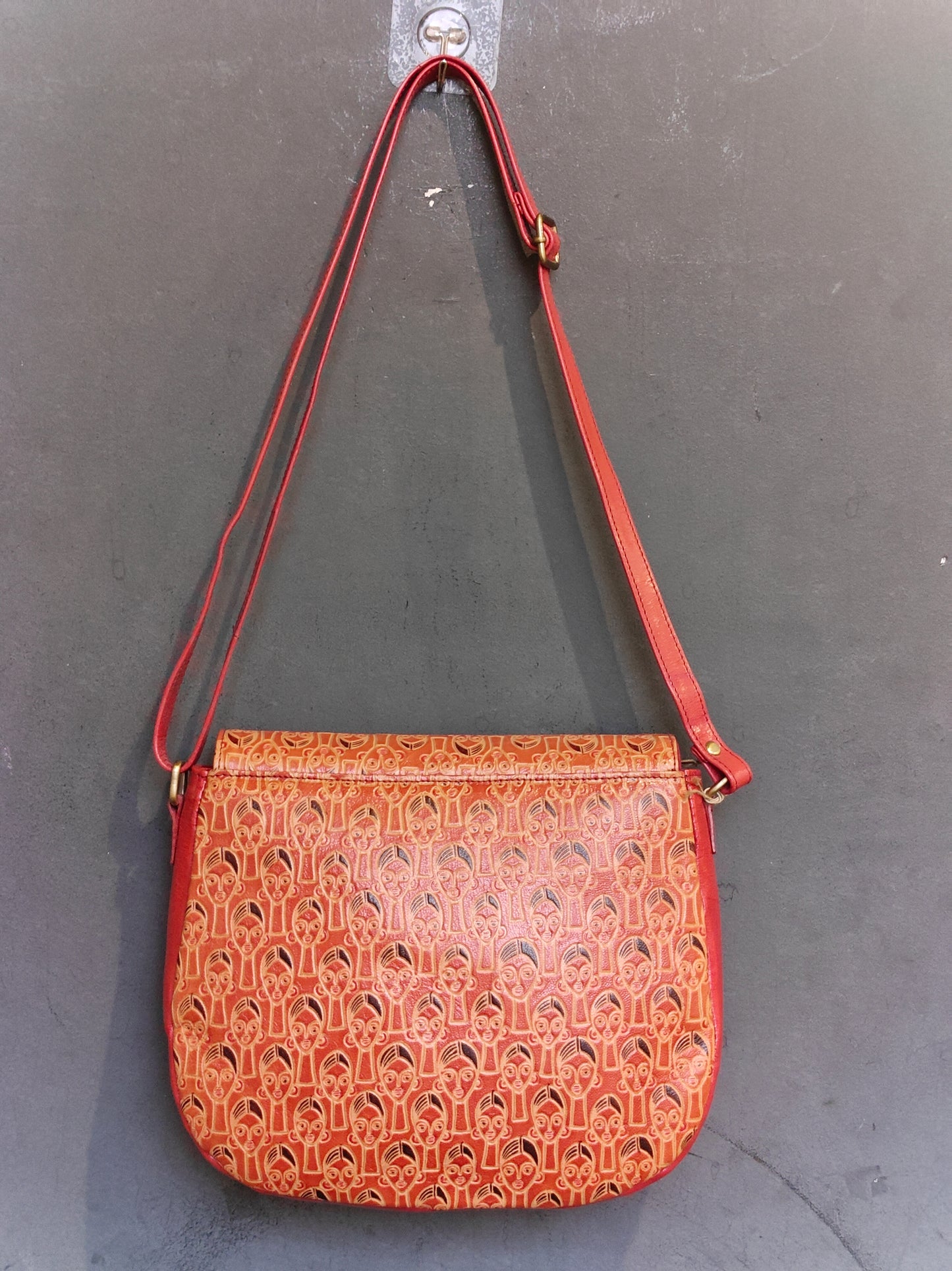 Leather hand crafted, hand painted adjustable length sling bag with metal clasp