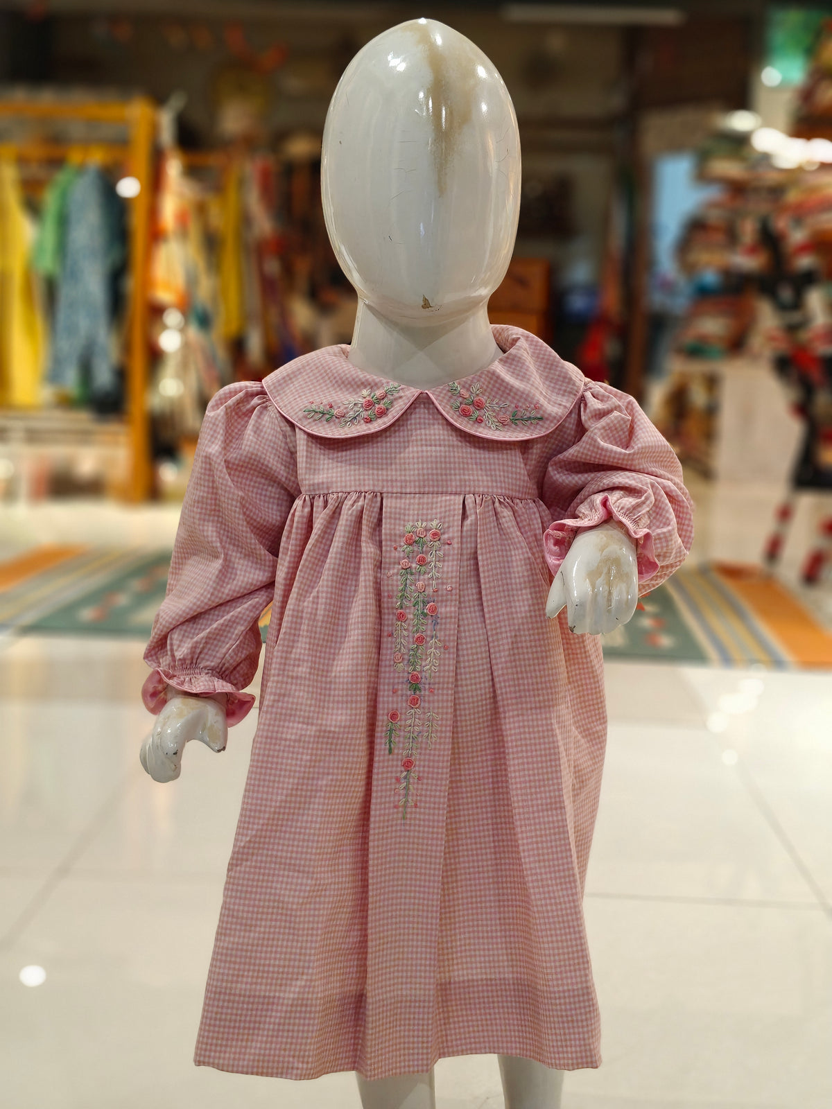Pink checks smocking cotton frock with floral embroidery on peter pan collar and centre box pleat for girls
