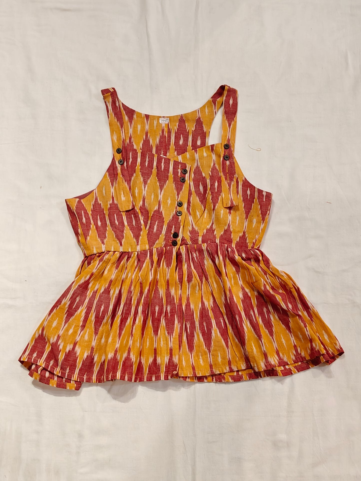 Orange and red ikat cotton button down sleeveless peplum top