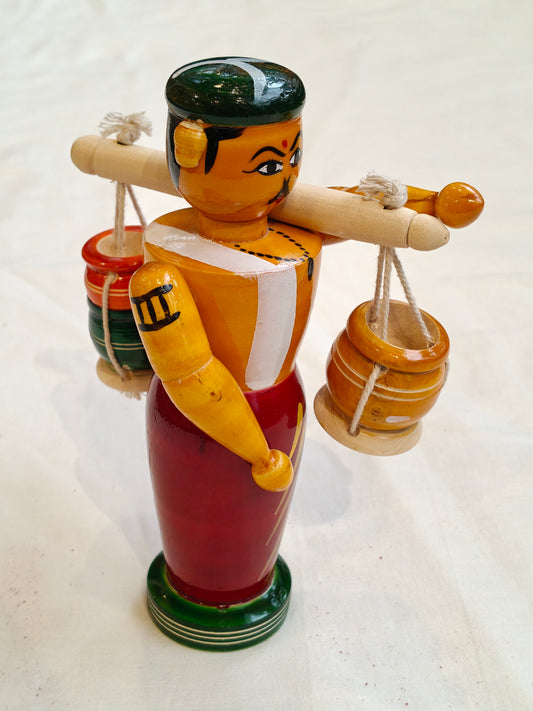 Man carrying pots by shoulder pole - Handcrafted wooden decor