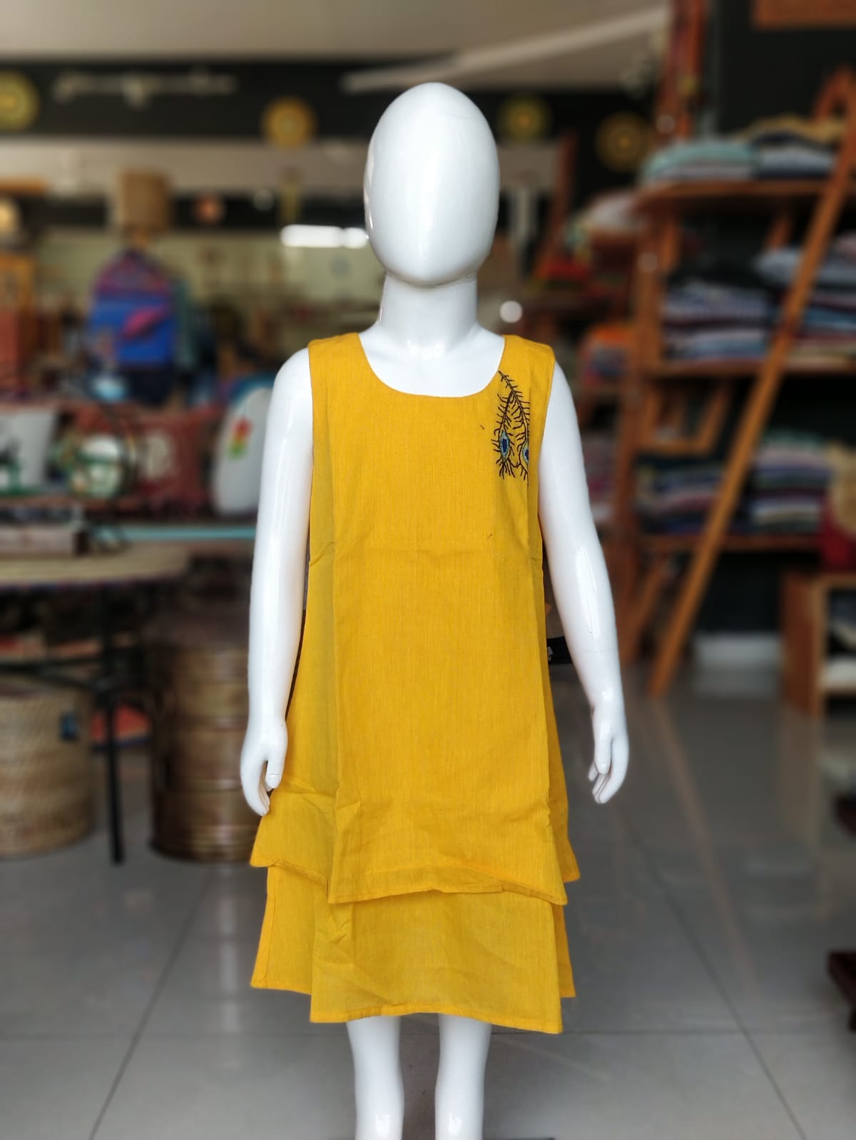 Yellow layered kanchi cotton frock for girls with peacock feather hand embroidery