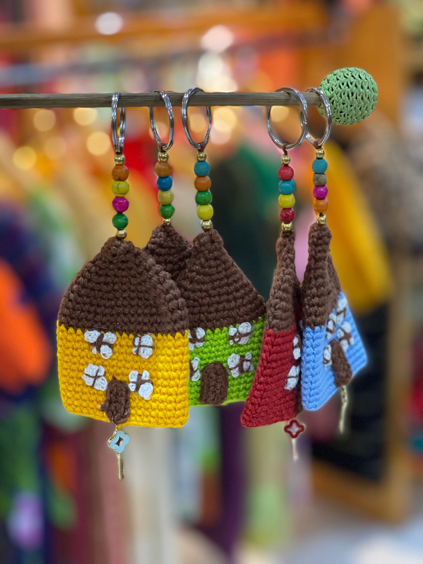 Colourful crochet hut keychain charms