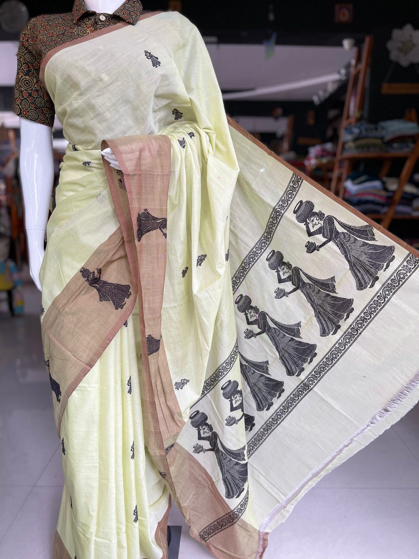 Exquisitely handwoven green gollabhama saree with big milk pot carrying women motifs