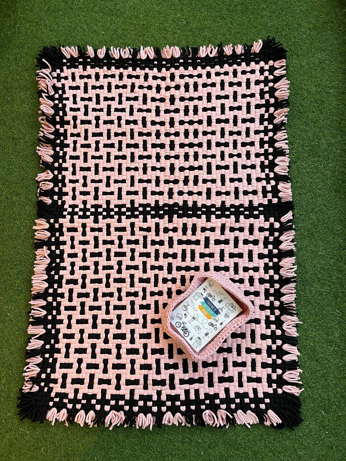 Pink and black handwoven upcycled knitted cotton rug