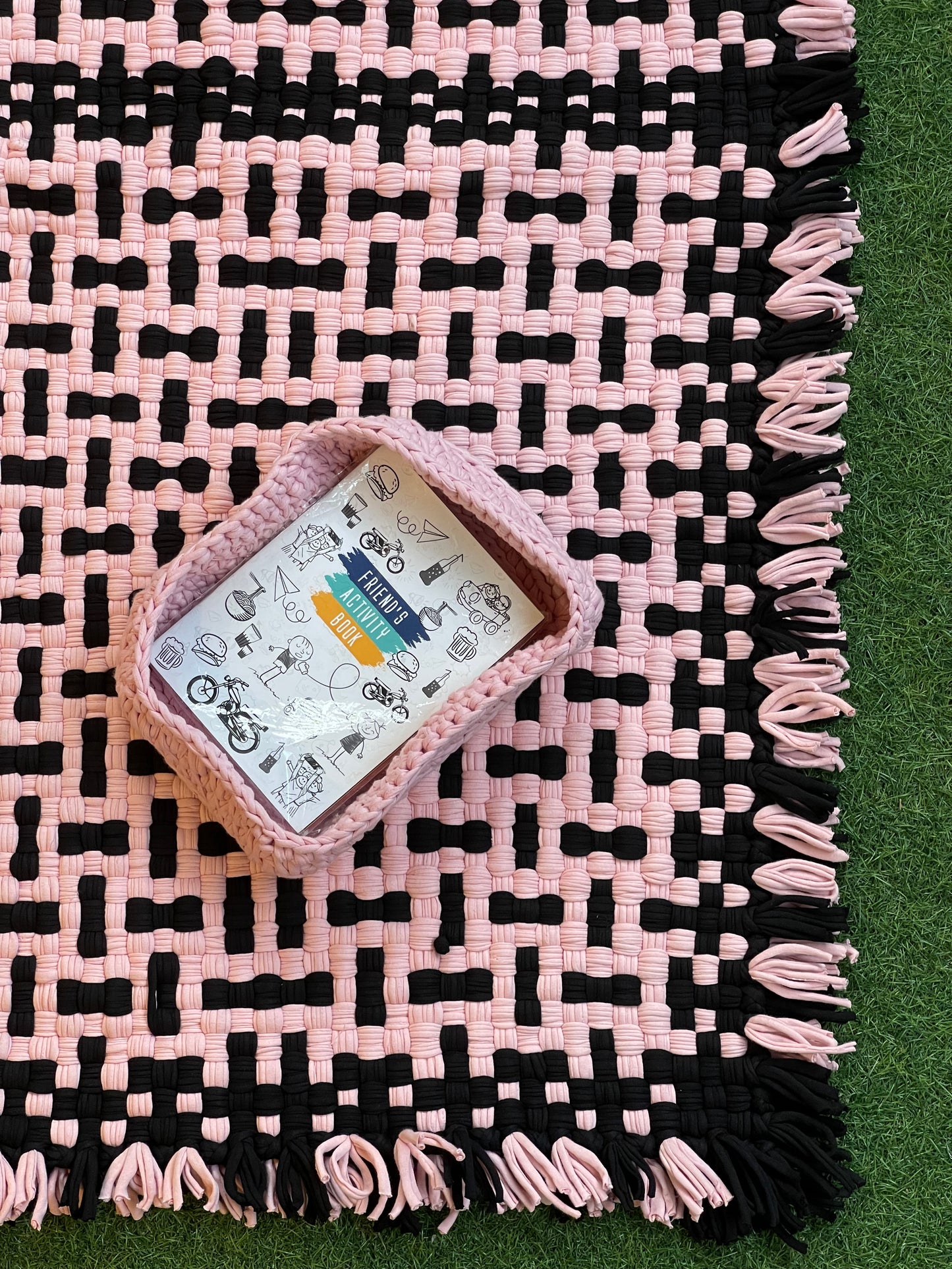 Pink and black handwoven upcycled knitted cotton rug