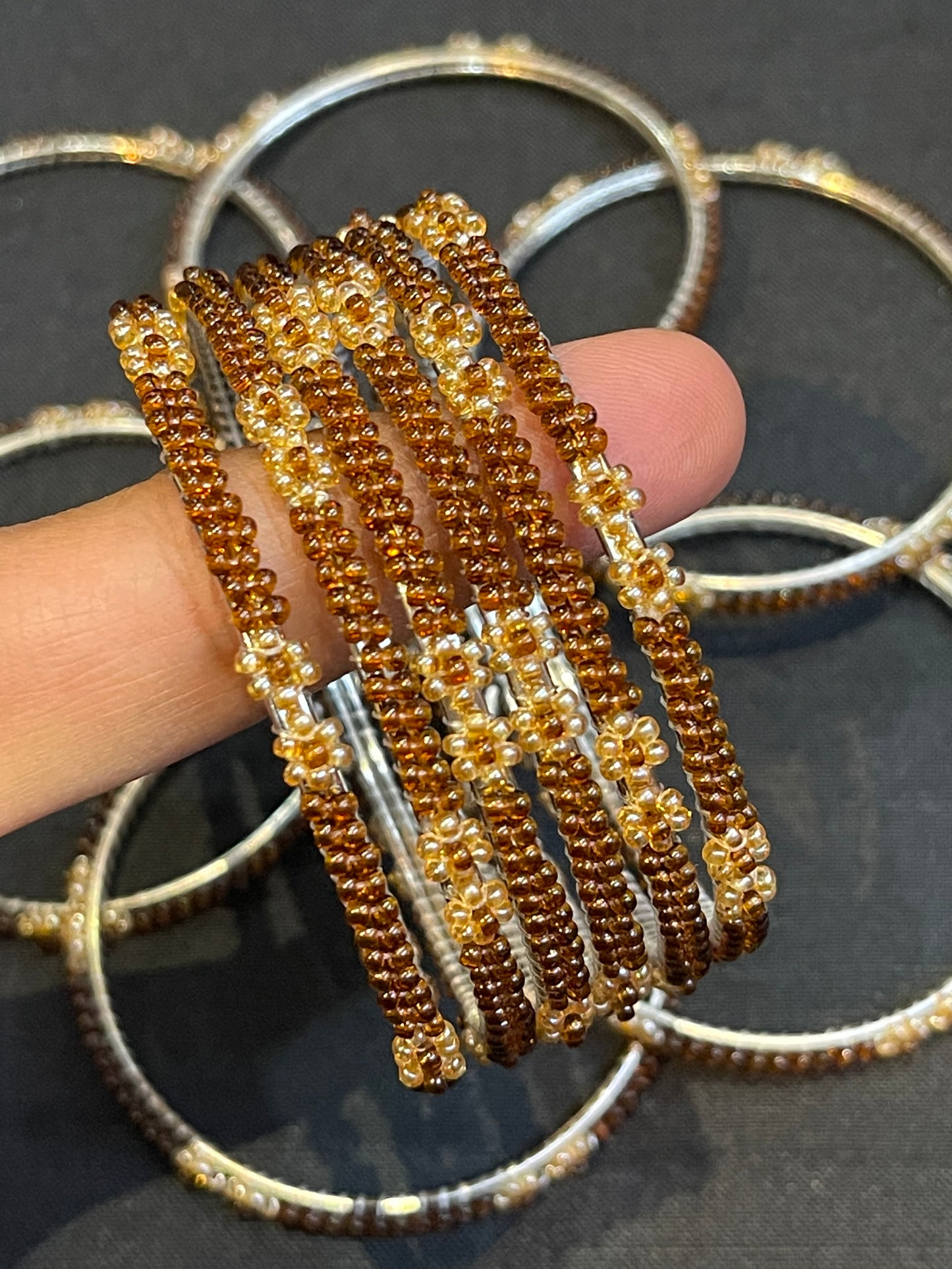 Brown and gold glass beads bangles on metal base