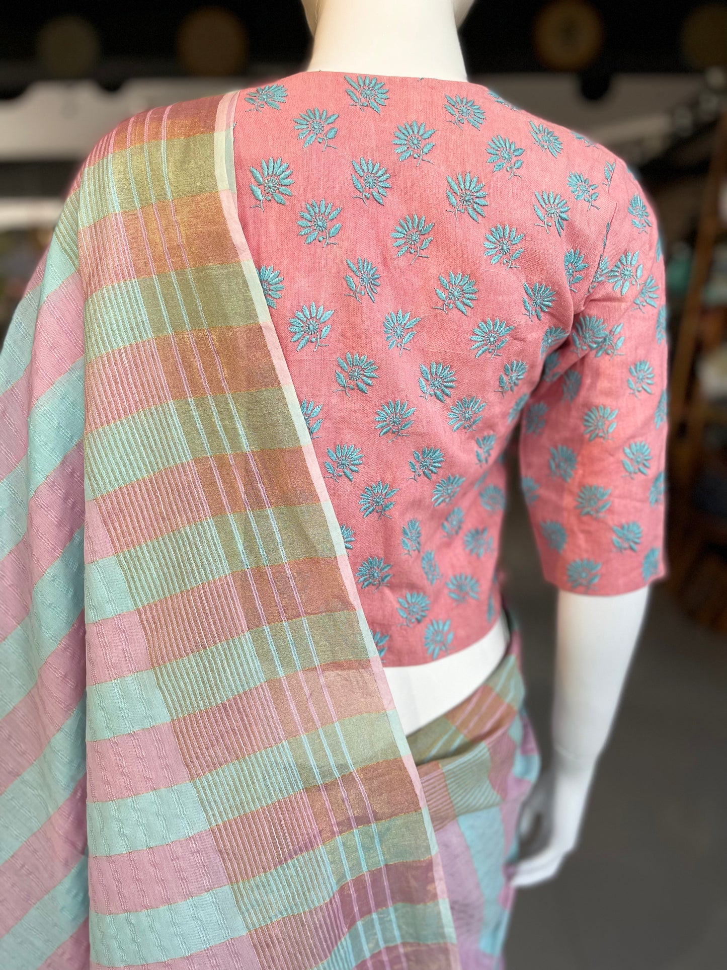 Pastel pink eri silk blouse with blue chikankari embroidery and side buttons