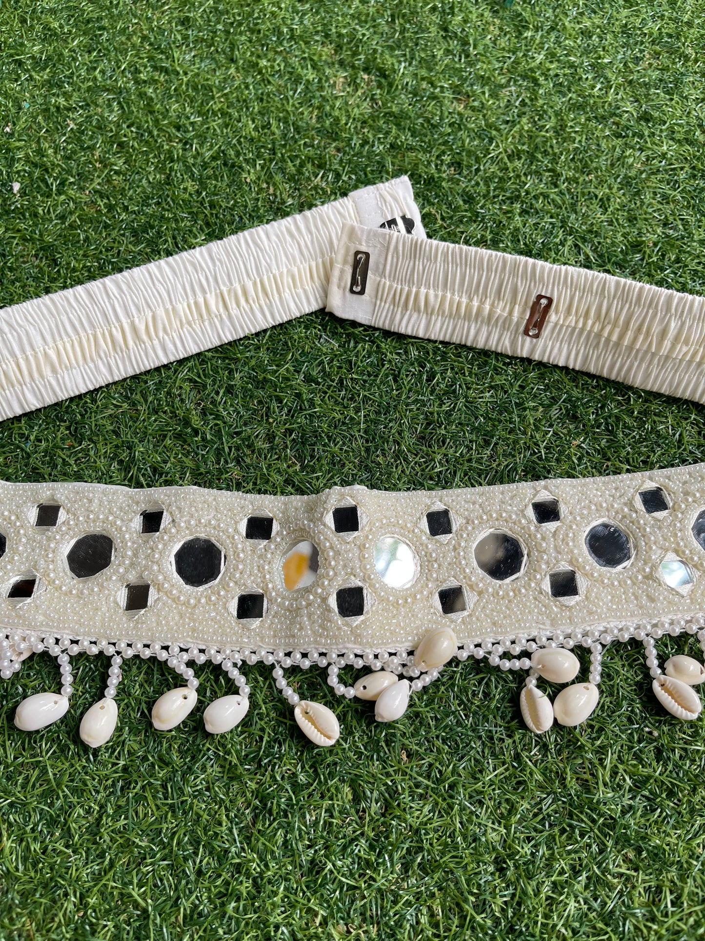 Round and square mirrors and beads work belt with cowries