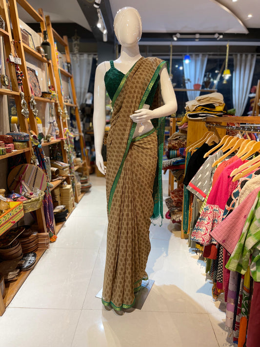 Chiffon light brown saree with green paisley border