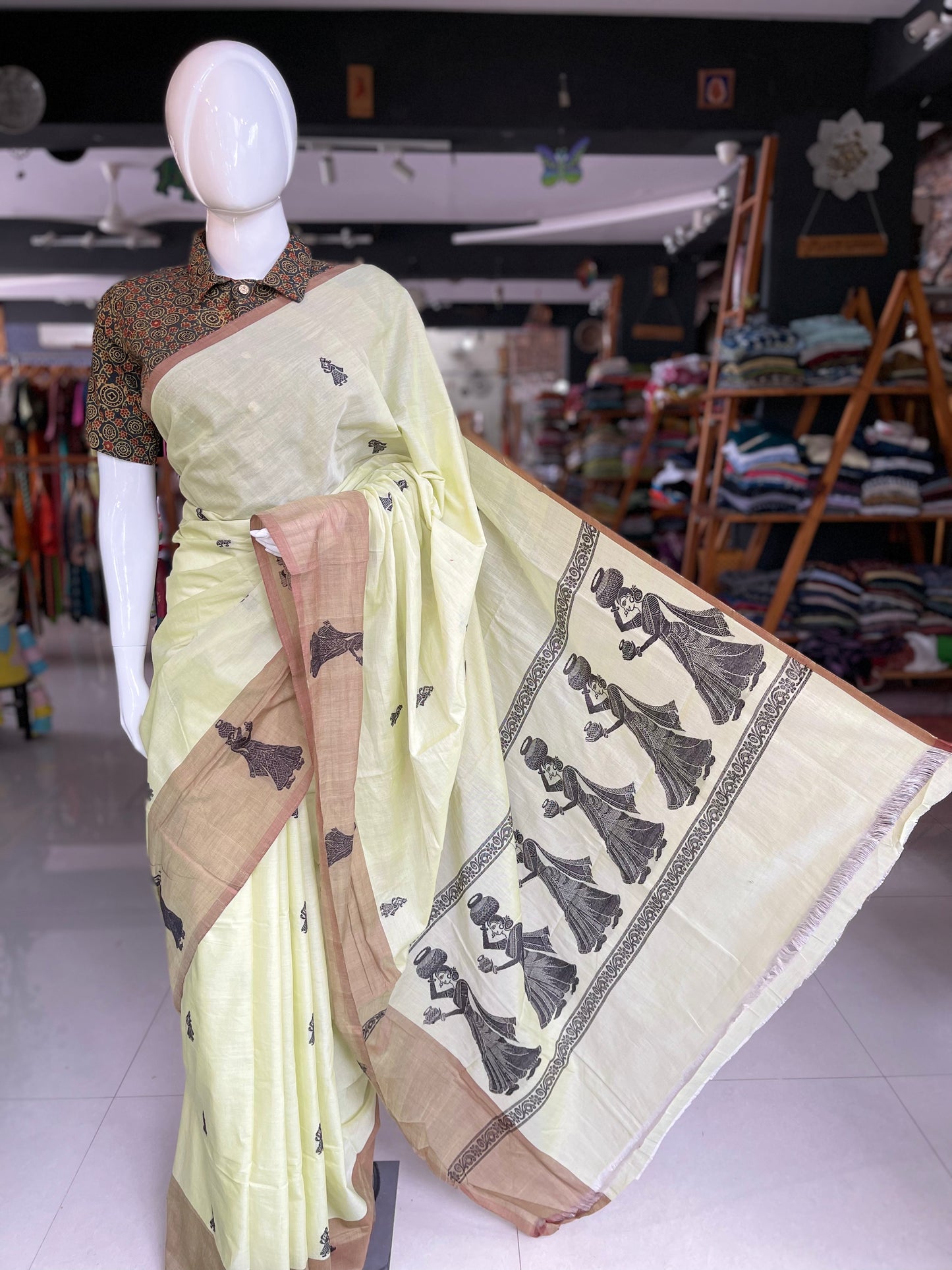 Exquisitely handwoven green gollabhama saree with big milk pot carrying women motifs